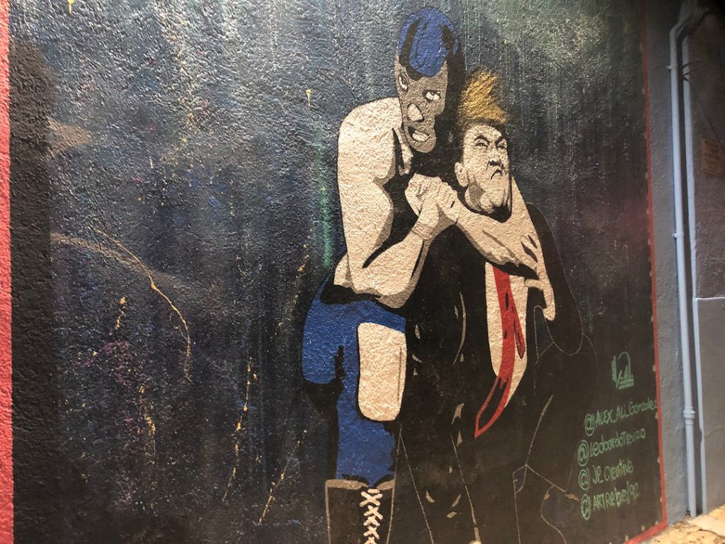 Blue Demon luchador with Donald Trump in a headlock at Boyle Heights Tavern in Boyle Heights. 