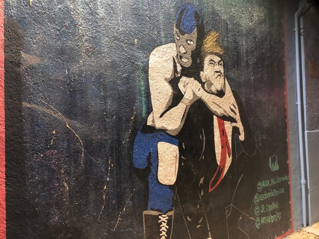 Blue Demon luchador with Donald Trump in a headlock at Boyle Heights Tavern in Boyle Heights.
