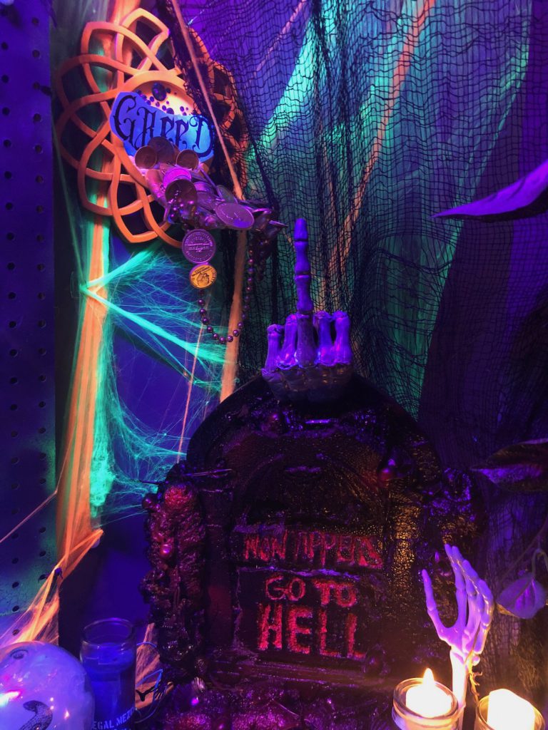 Skeleton hand raising its middle finger from above a tombstone in Halloween display at The Mermaid in Little Tokyo. (Photo: Liz Ohanesian)