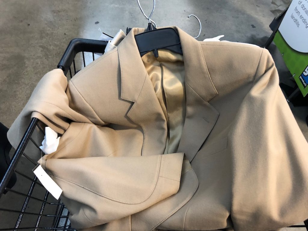 Halloween costume shopping at Goodwill Glassell Park. A khaki blazer and white shirt inside a shopping cart. (Photo: Liz Ohanesian)