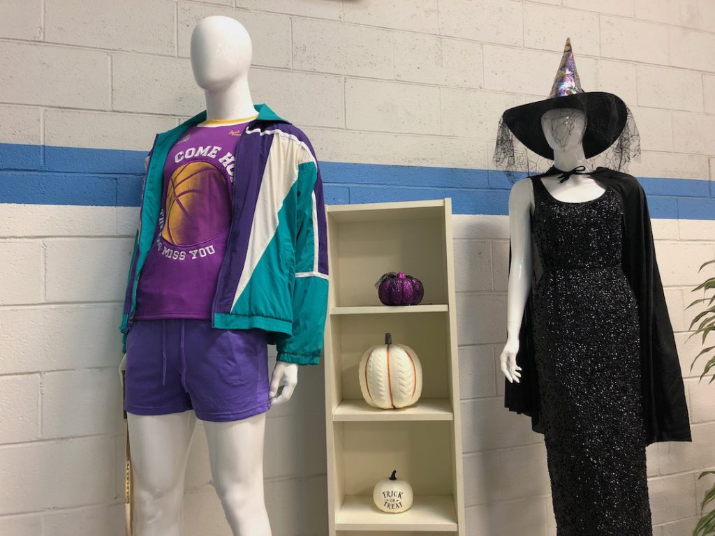 Spotted while halloween costume shopping at Goodwill Glassell Park. One mannequin dressed as a tennis place wearing purple shorts and t-shirt, teal windbreaker. One mannequin dressed as a witch in a glittery black dress and witch hat with cobweb veil. (Photo: Liz Ohanesian)