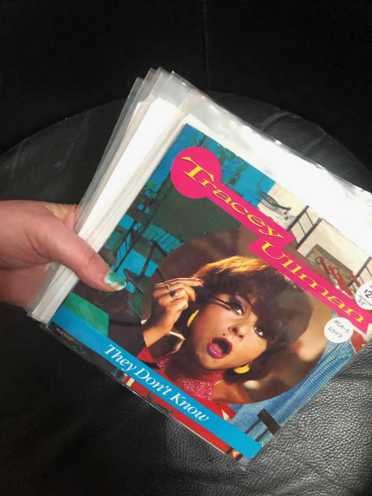 A stack of vinyl 45s purchased at Penny Lane in Upland with Tracey Ullman "They Don't Know" single on top.