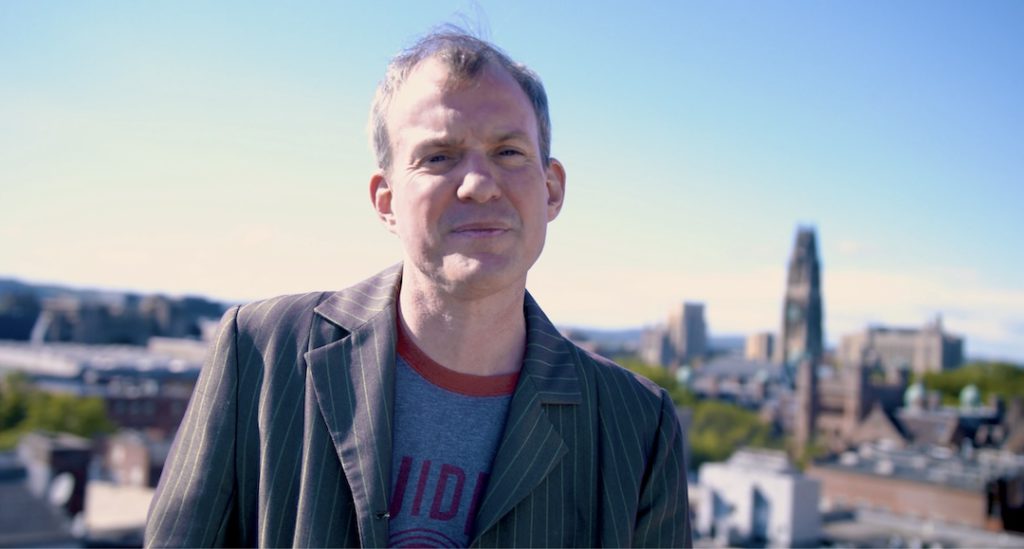 Aug Stone musician and author of Ballad of Buttery Cake Ass and Sporting Moustaches "Rachel on the Rooftops" video still. 