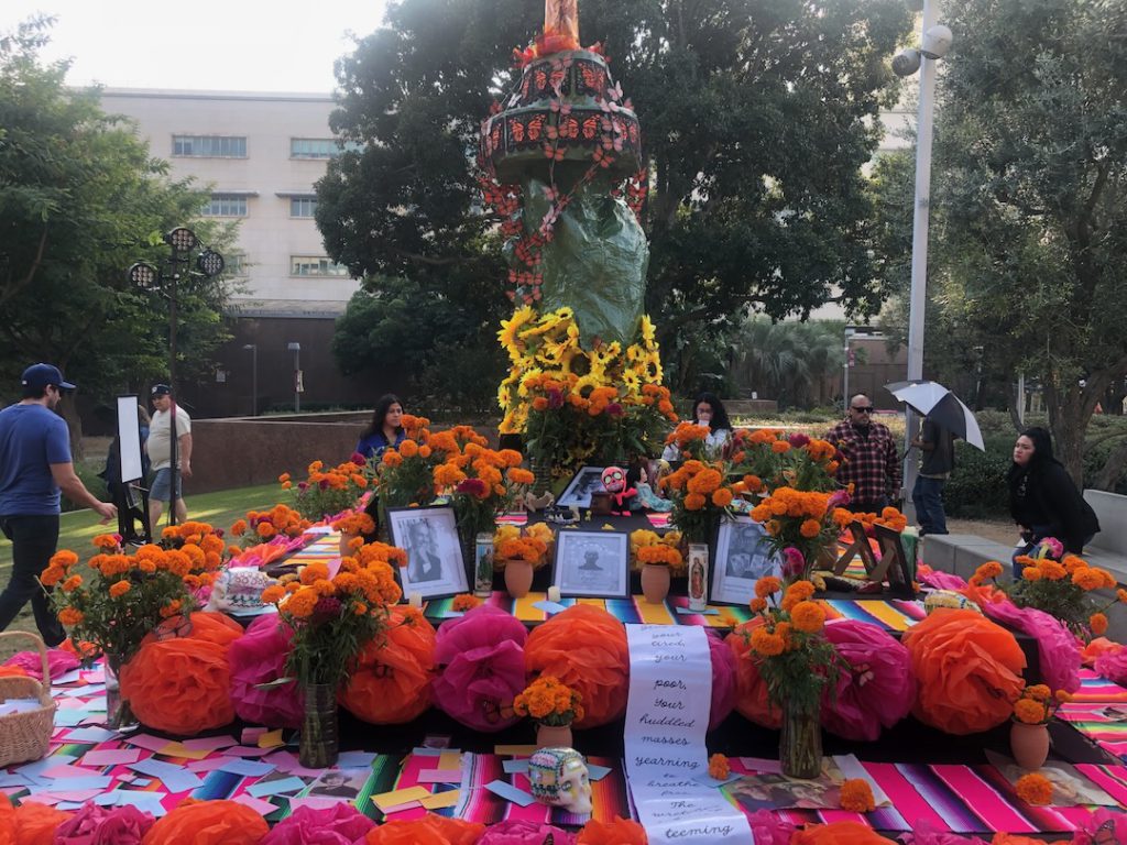 Dia de los Muertos altar at Gloria Molina Grand Park in Los Angeles with a hand and torch resembling the Statue of Liberty in the middle (Photo: Liz Ohanesian)
