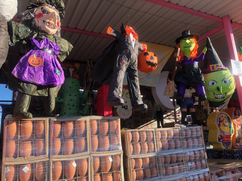 Three witch piñatas and one headless jack-o-lantern piñata inside Los Angeles Piñata District (Photo: Liz Ohanesian)