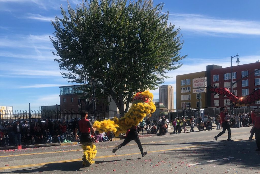 Lion dancers running down Broadway during the 127th annual Golden Dragon Parade in LA Chinatown February 21, 2026 (Photo: Liz Ohanesian