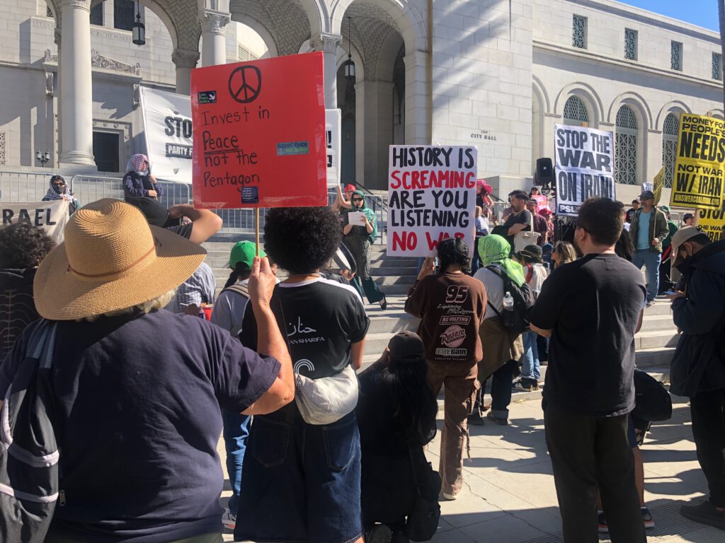 Photo of antiwar protestors in front of Los Angeles City Hall on March 7, 2026 (Photo: Liz Ohanesian)